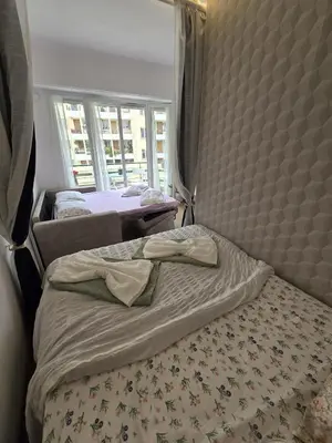 a bedroom with two beds and a window at Gloria apartments in Nice