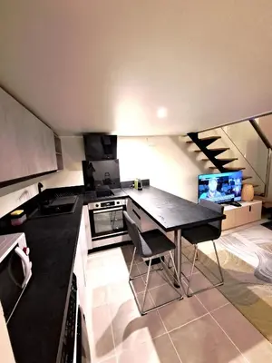a small kitchen with a table and a stove at Massena square View 2 min to the beach & the old town in Nice