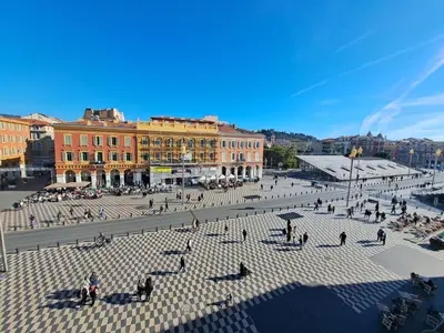 a group of people walking around a plaza at Massena square View 2 min to the beach & the old town in Nice