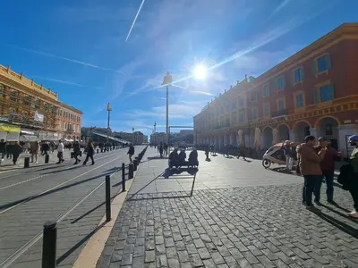 a group of people walking on a street at Massena square View 2 min to the beach & the old town in Nice
