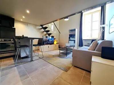 a living room with a couch and a table at Massena square View 2 min to the beach & the old town in Nice