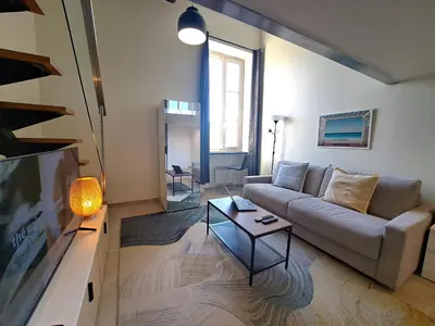 a living room with a couch and a table at Massena square View 2 min to the beach & the old town in Nice