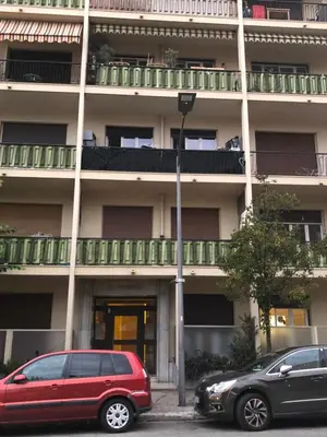 two cars parked in front of a building at Escapades Ensoleillées in Nice