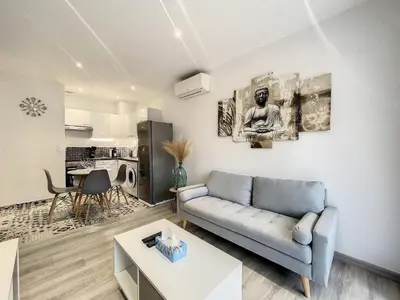 a living room with a couch and a table at Escapades Ensoleillées in Nice