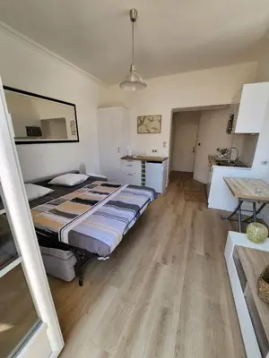 a bedroom with a bed and a table in it at AMAZING STUDIO - GRANDE TERRASSE - COEUR DE VILLE - WIFI - AC in Nice