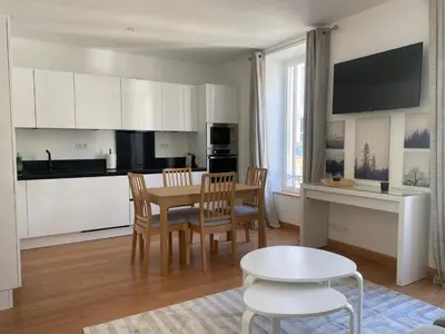 a kitchen and dining room with a table and chairs at PACA01 in Nice