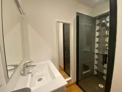 a white bathroom with a sink and a shower at PACA01 in Nice