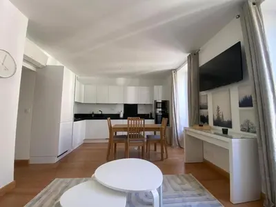 a kitchen and dining room with a table and chairs at PACA01 in Nice
