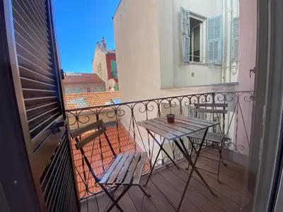 a balcony with a table and chairs on a balcony at PACA01 in Nice