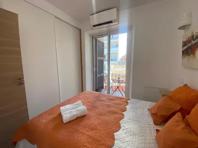 a bedroom with a bed with a towel on it at PACA01 in Nice