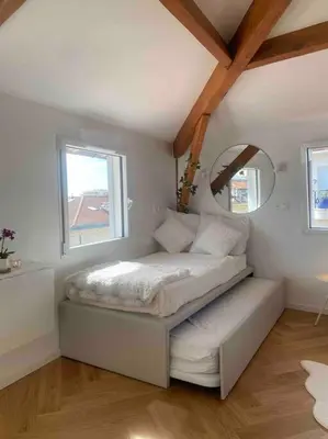 a bedroom with a bed with a mirror and a window at Heart of Nice-Rooftop Seaside Studio in Nice
