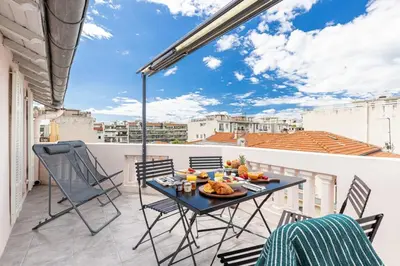 a patio with a table and chairs on a balcony at MY CASA - SPITALIERI 2 - Superb Terrace Panoramic View AC in Nice