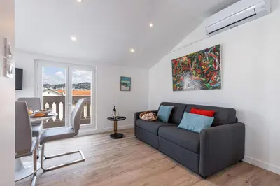a living room with a couch and a table at MY CASA - SPITALIERI 2 - Superb Terrace Panoramic View AC in Nice