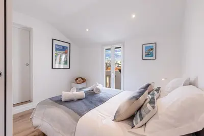 a white bedroom with a large bed in it at MY CASA - SPITALIERI 2 - Superb Terrace Panoramic View AC in Nice