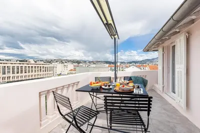 a table and chairs on a balcony with a view at MY CASA - SPITALIERI 2 - Superb Terrace Panoramic View AC in Nice