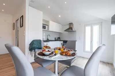 a kitchen and dining room with a table with food on it at MY CASA - SPITALIERI 2 - Superb Terrace Panoramic View AC in Nice