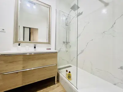 a bathroom with a shower and a sink and a mirror at Sublime Appartement 2 pièces au cœur de la Vieille Ville in Nice