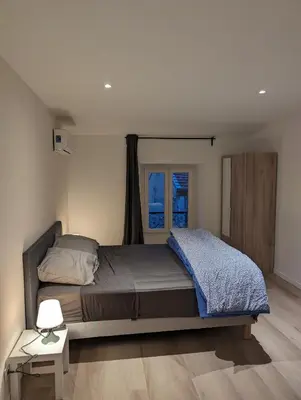 a bedroom with a large bed and a window at Holiday Nice Studio in Nice