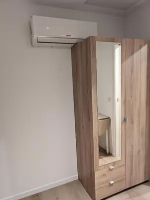 a bathroom with a wooden cabinet with a mirror at Holiday Nice Studio in Nice
