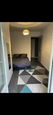 a bedroom with a bed and a checkered floor at Chez Nico in Nice