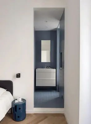 a bedroom with a bathroom with a sink and a mirror at Luxury flat for 6 in center of Nice By ask me france in Nice