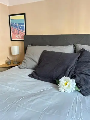 a white flower sitting on top of a bed at Studio lumineux avec balcon à proximité de la mer in Nice