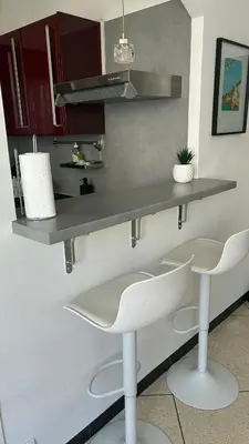 a kitchen with two white chairs and a counter at Nice Séjour Detente Studio Lumineux Balcon Cuisine Equipée Wifi in Nice