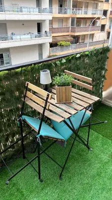 a bench on a balcony with a table and a lamp at Nice Séjour Detente Studio Lumineux Balcon Cuisine Equipée Wifi in Nice