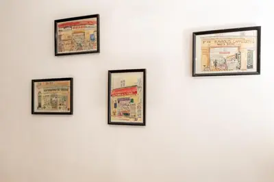 a wall with four framed photos on a white wall at 26 nice Vieux Nice in Nice