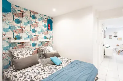 a bedroom with a bed with a colorful wall at 26 nice Vieux Nice in Nice