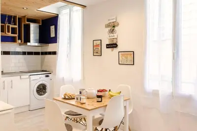 a kitchen with a table and chairs in a room at 26 nice Vieux Nice in Nice