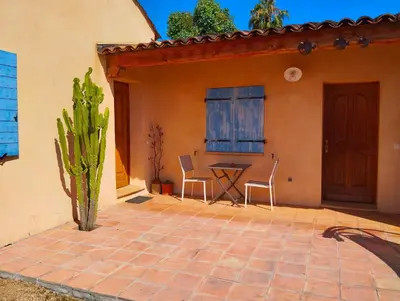 a patio with a table and chairs in front of a house at L'Albizia in Nice