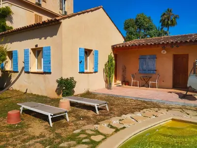 a house with a backyard with a pool and a table at L'Albizia in Nice