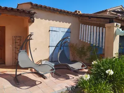 two chairs sitting on a patio in front of a house at L'Albizia in Nice