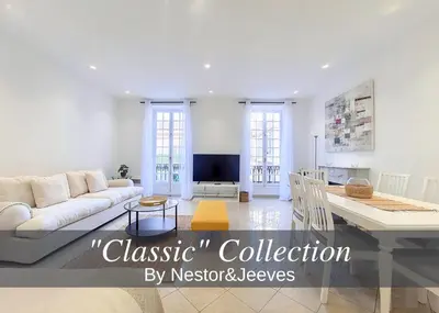 a living room with a couch and a tv at Nestor&Jeeves - JACARANDA - Carre d Or, Proche mer in Nice