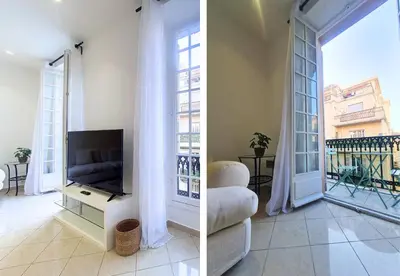 a living room with a tv and a large window at Nestor&Jeeves - JACARANDA - Carre d Or, Proche mer in Nice