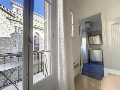 a door to a balcony with a view of a building at Nestor&Jeeves - JACARANDA - Carre d Or, Proche mer in Nice