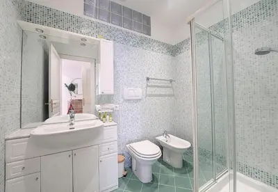 a bathroom with a sink and a toilet and a shower at Nestor&Jeeves - JACARANDA - Carre d Or, Proche mer in Nice