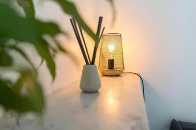a small lamp sitting on a table with a plant at Nice Centre STUDIO avec BALCON in Nice