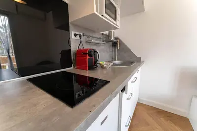 a kitchen with a red appliance on a counter at Nice Centre STUDIO avec BALCON in Nice