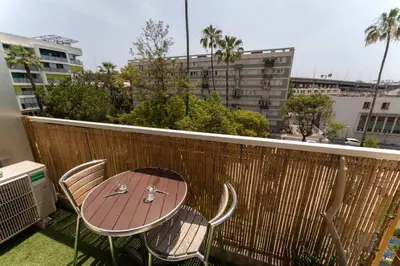 a patio table and chairs on a balcony with a city at Nice Centre STUDIO avec BALCON in Nice