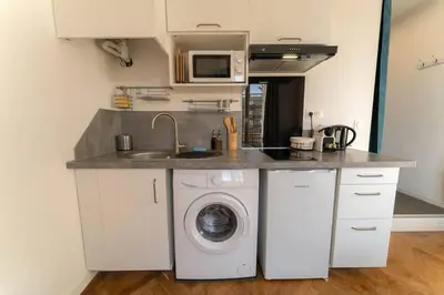 a kitchen with a sink and a washing machine at NICE CENTRE-VILLE STUDIO en étage in Nice