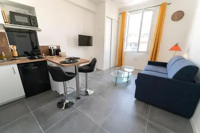 a living room with a blue couch and a table at NICE Centre-ville Studio en étage refait à neuf in Nice
