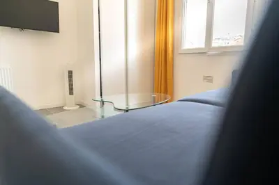 a bedroom with a bed and a glass table at NICE Centre-ville Studio en étage refait à neuf in Nice