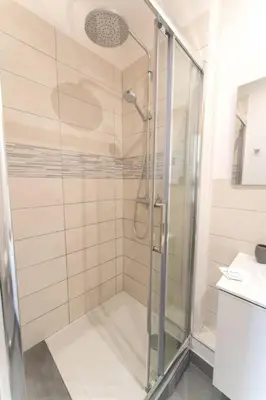 a shower with a glass door in a bathroom at NICE Centre-ville Studio en étage refait à neuf in Nice