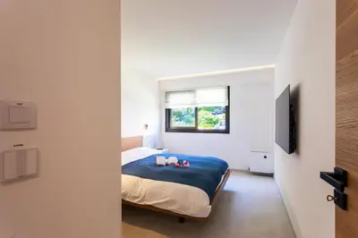 a bedroom with a bed with two candles on it at Agrianthe Palmiers AP4380 By Riviera Holiday Homes in Villefranche-sur-Mer
