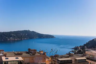 a view of a large body of water with boats at Agrianthe Palmiers AP4380 By Riviera Holiday Homes in Villefranche-sur-Mer