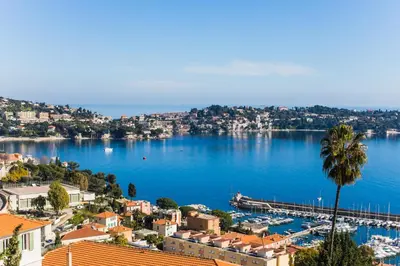 a view of a city and a harbor at Agrianthe Palmiers AP4380 By Riviera Holiday Homes in Villefranche-sur-Mer