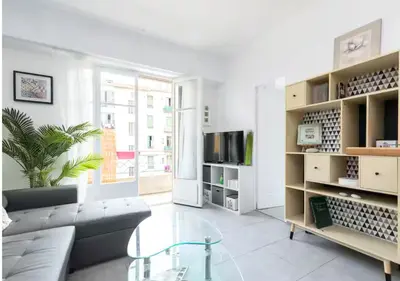 a living room with a couch and a glass table at Beautiful & spacious 2 bed Apt near Nice Center in Nice