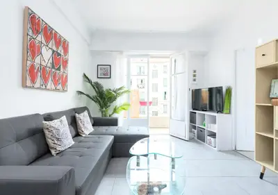 a white bedroom with a white bed and a desk at Beautiful & spacious 2 bed Apt near Nice Center in Nice